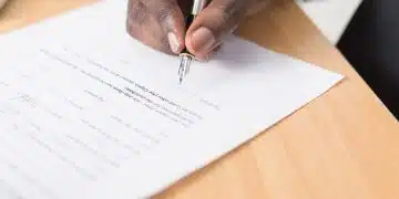 person writing on white paper