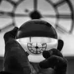 grayscale photography of person holding glass ball