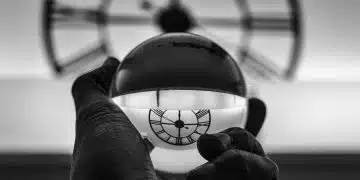 grayscale photography of person holding glass ball