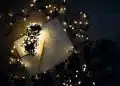 photo of string lights on open book beside pencil